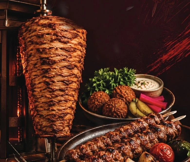 The Mashahweez grill, shawarma cone, falafel and kabab, live over the fire
